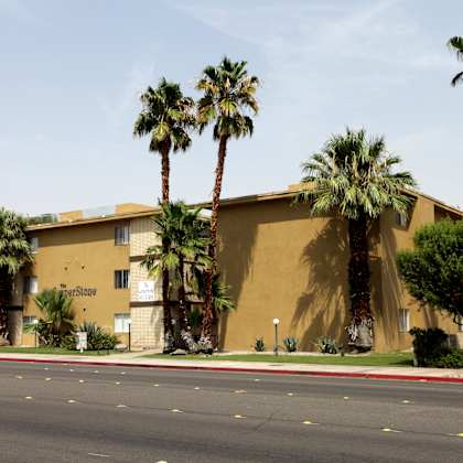 a building with palm trees in front of it.