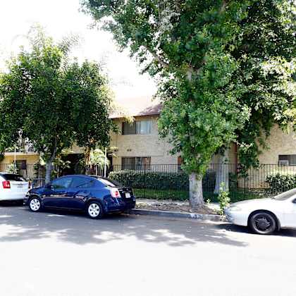 three cars parked in front of a building.