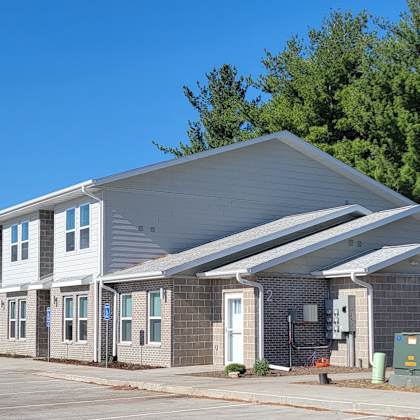 a modern building with a grey roof and white walls.