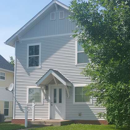 a house with a white door and windows.