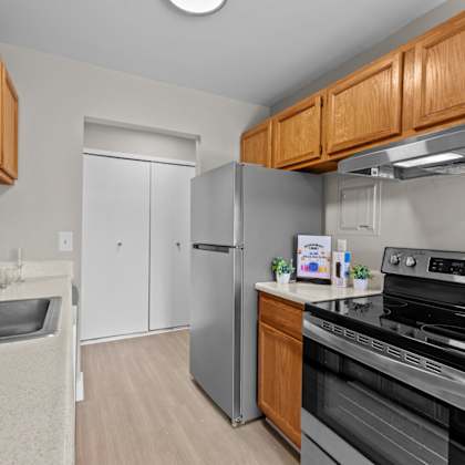 a kitchen with wooden cabinets and stainless steel appliances.