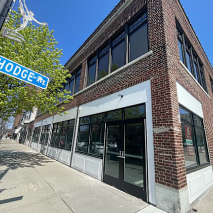 a street view of a building with a sign that says hodge me.