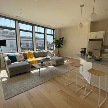 a living room with a grey couch and a coffee table.