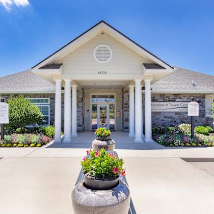 the front of a building with flowers in front of it at aventura at towne centre, missouri