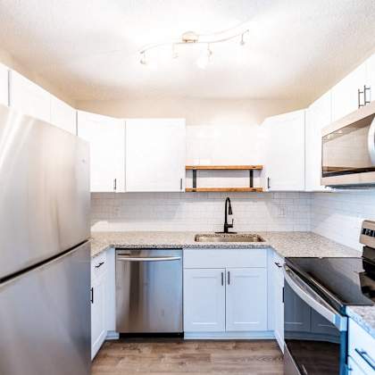 a kitchen with a sink and a refrigerator.