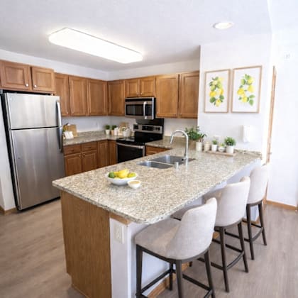 a kitchen with a granite countertop and stainless steel appliances.