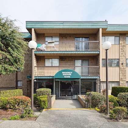 the image shows a multi-story apartment building with a green awning and a sign that reads "apartment suites."