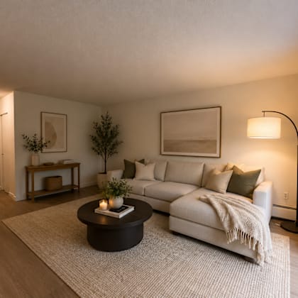 a modern living room with a white couch and a coffee table.