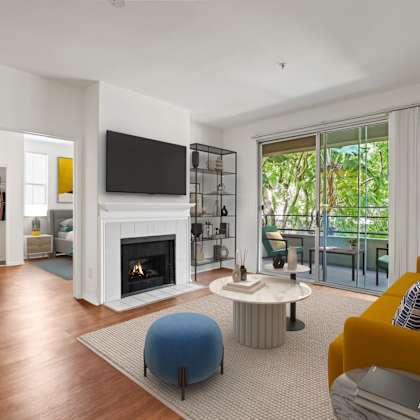 living room with fireplace, vinyl flooring, and patio