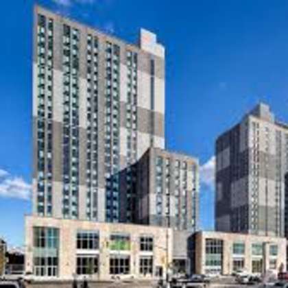 a rendering of a tall building in the middle of a city