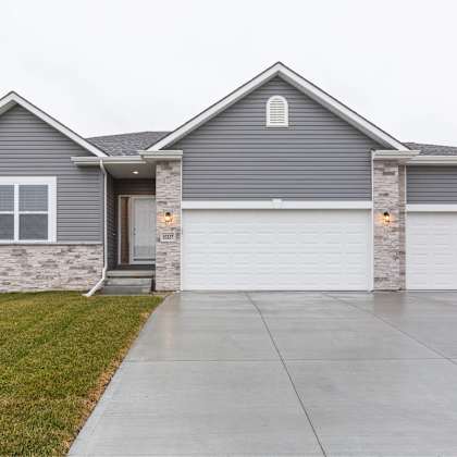 a grey house with a white garage door.