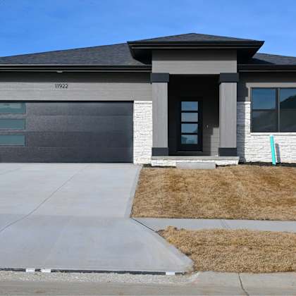 a modern house with a garage door and a driveway.