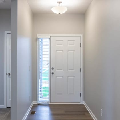 a white door is in the middle of a hallway.