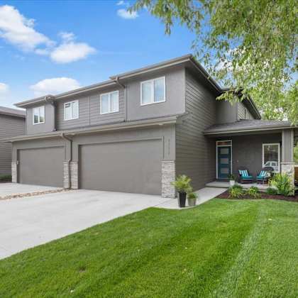 a house with a grey garage door and a blue door.