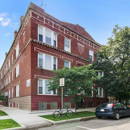 a red brick building with a bicycle parked in front.