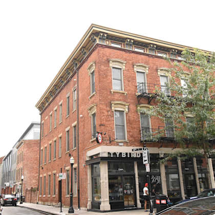 exterior of brick apartment building on the corner of a street