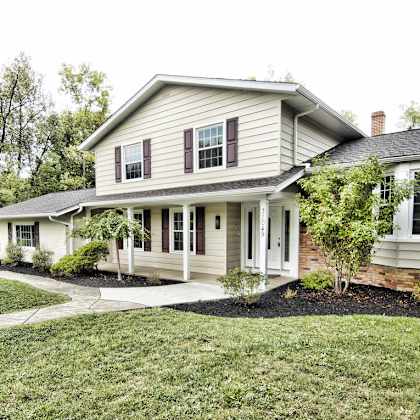 a house with a white exterior and a grey roof..