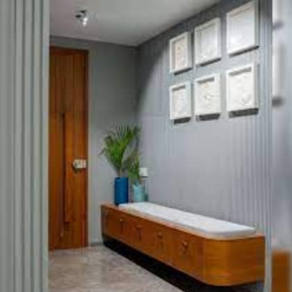 a room with a bench and pictures on the wall