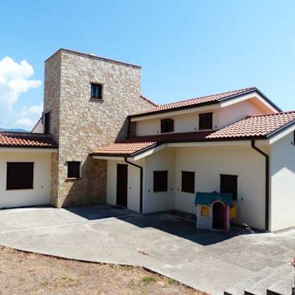 a house with a tower-like structure on the left side.