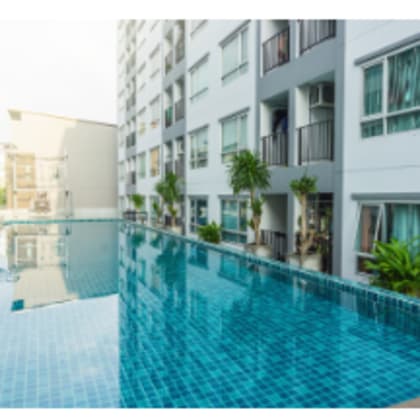 a large swimming pool in front of a building