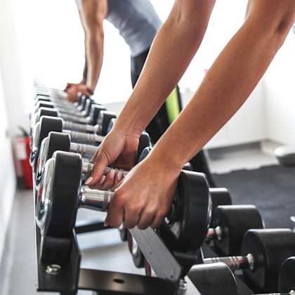 people working out on weights at a gym