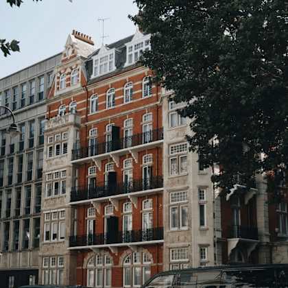 a row of buildings with a red building in the middle.