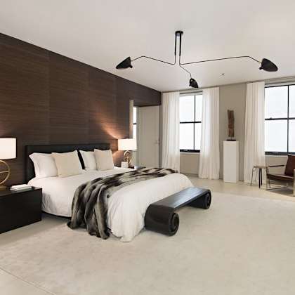 a modern bedroom with a large bed and a chair.