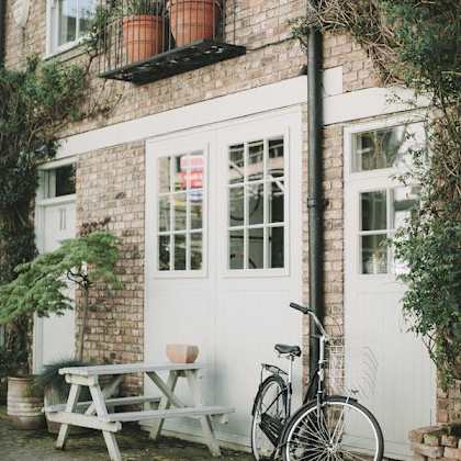 a bicycle is parked next to a white door.