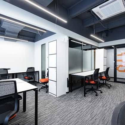 a modern office space with black chairs and white desks.