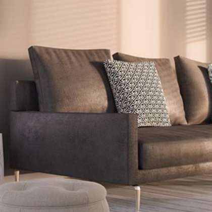 A modern living room with a brown couch and a white side table.