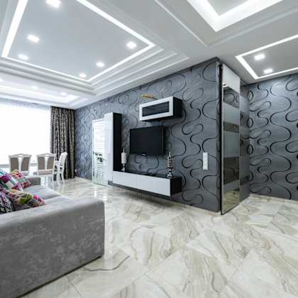 a modern living room with a grey sofa and a television.
