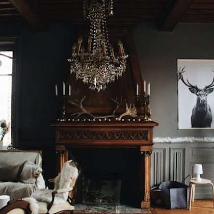 a living room with a fireplace and a chandelier