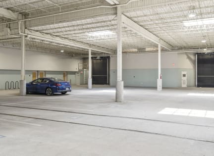 a blue car parked in a parking garage