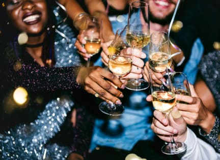 a group of people holding wine glasses at a party