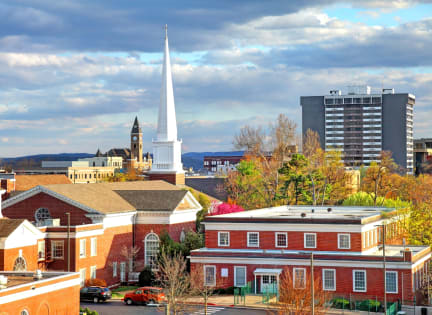 a view of the city of providence with a church steeple and other buildings
