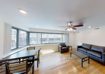 a living room with leather furniture and a large window