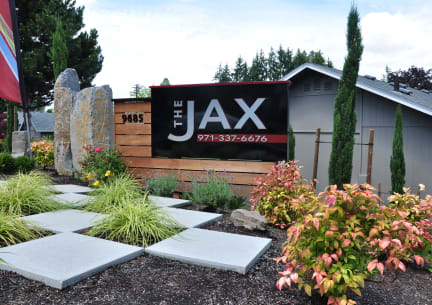 the front of the jax sign in the front yard of a house