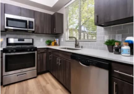a kitchen with stainless steel appliances and wooden cabinets