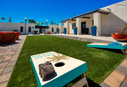 a seating area with a bean bag chair and a bench in front of a building