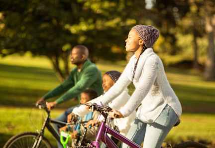a group of people riding bikes in a park