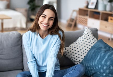 a woman sitting on a couch in a living room