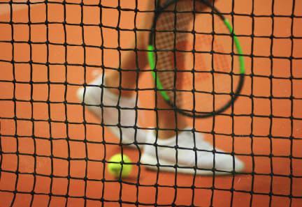a tennis player holding a racket on a tennis court