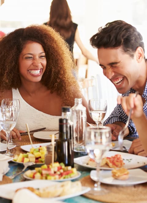 a group of people sitting around a table eating food