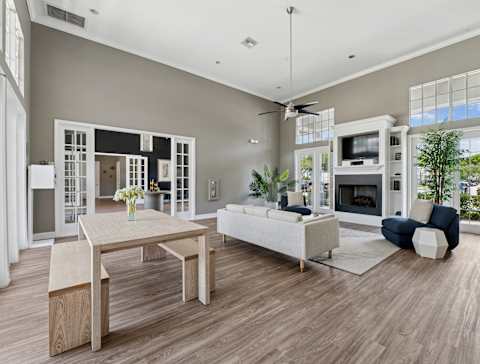 A modern clubhouse with a dining table and a sofa.