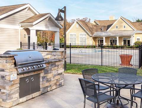 a patio with a barbecue grill and a table and chairs at Garden Springs, Chester