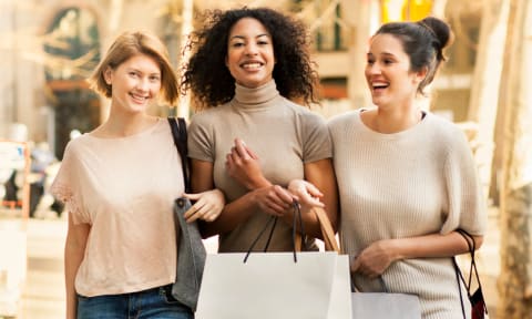 a group of women walking down the street with shopping bags at Lake Johnson Mews, Raleigh