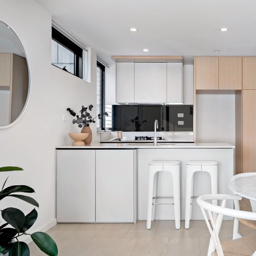 a kitchen and dining area with a white table and chairs