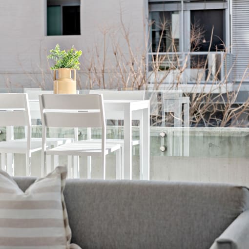 a living room with a couch and a table with chairs