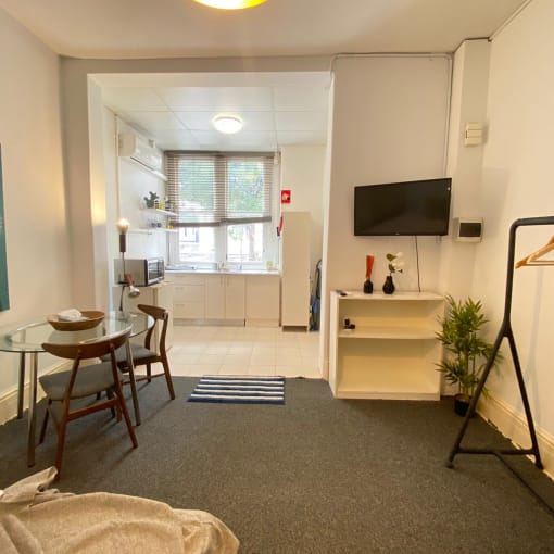 a living room with a table and a television