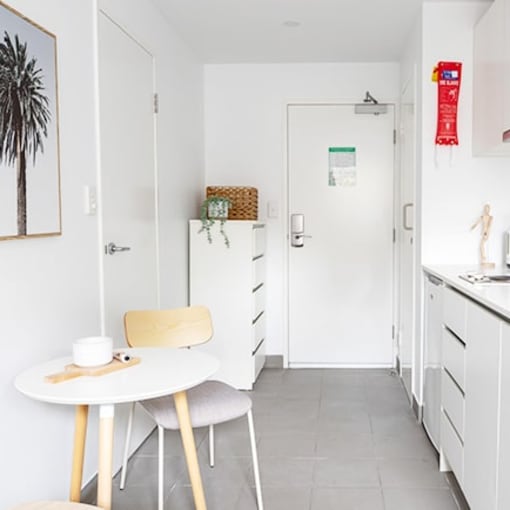 a white kitchen with a table and a sink